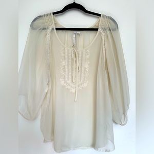 Sheer, cream colored blouse w/ embroidered flower design